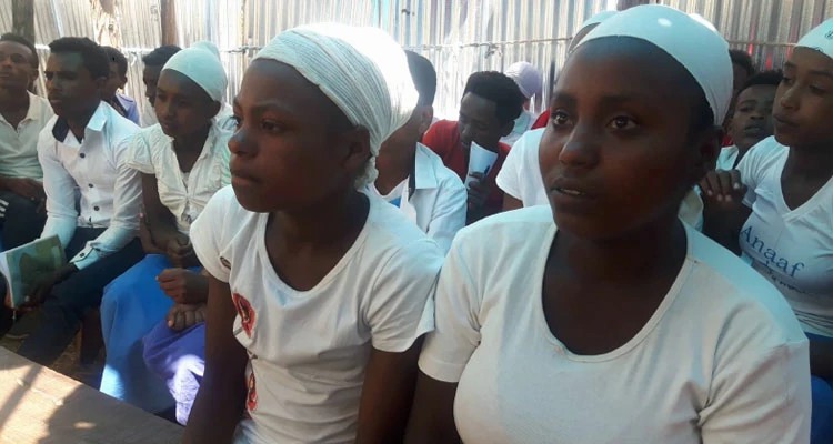 Meninas africanas ouvindo Berhane compartilhar sobre Jesus